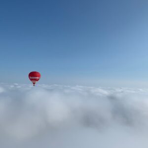 Hot Air Balloon flying over the clouds